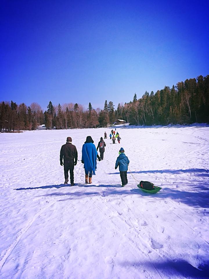 Actors and children walking on frozen lake