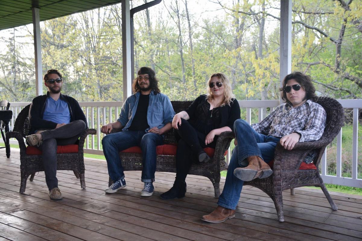 The Ollivanders promo shot - band members sitting on deck