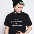 Photograph of Kairyn Potts, wearing a black beanie and a shirt that reads "My queerness is traditional."