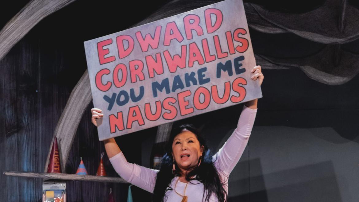 A character holding a sig aloft that says "Edward Cornwallis Makes Me Nauseous"