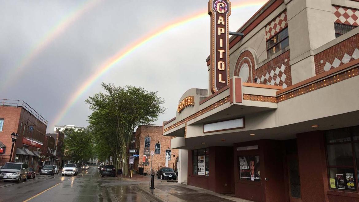capitol theatre with two rainbows in the sky