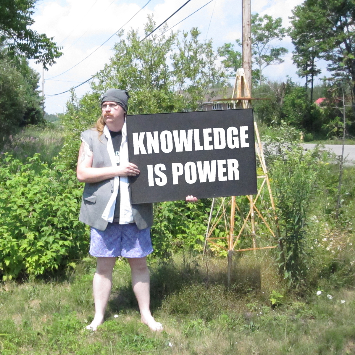 Clayton Windatt holding Knowledge is Power sign